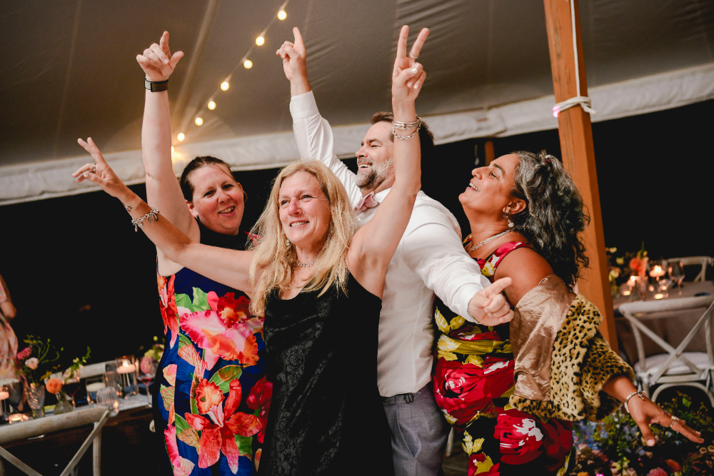 Guests fill the dance floor as the music picks up.