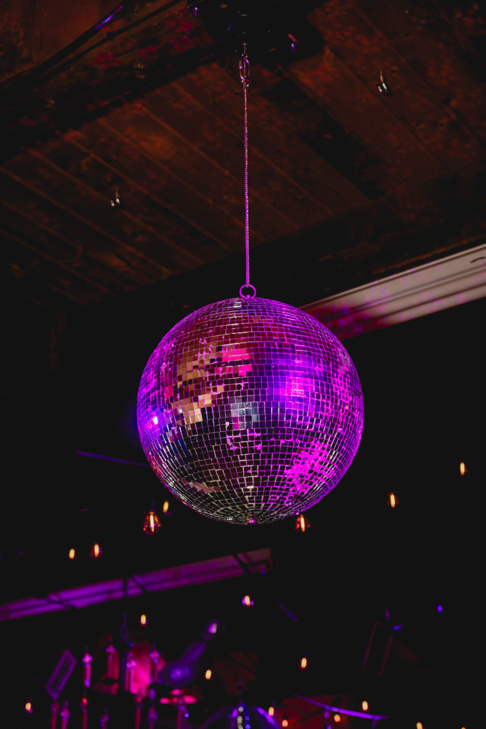 A shimmering mirror ball hanging above the dance floor for the retro celebration.