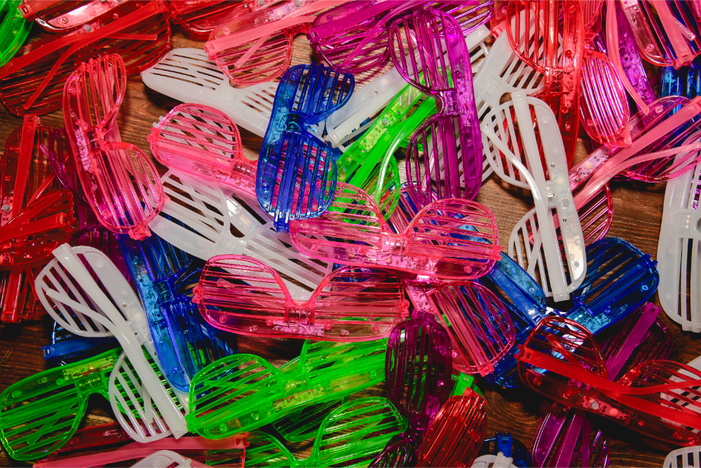 Neon sunglasses handed out as playful props at the wedding after party.