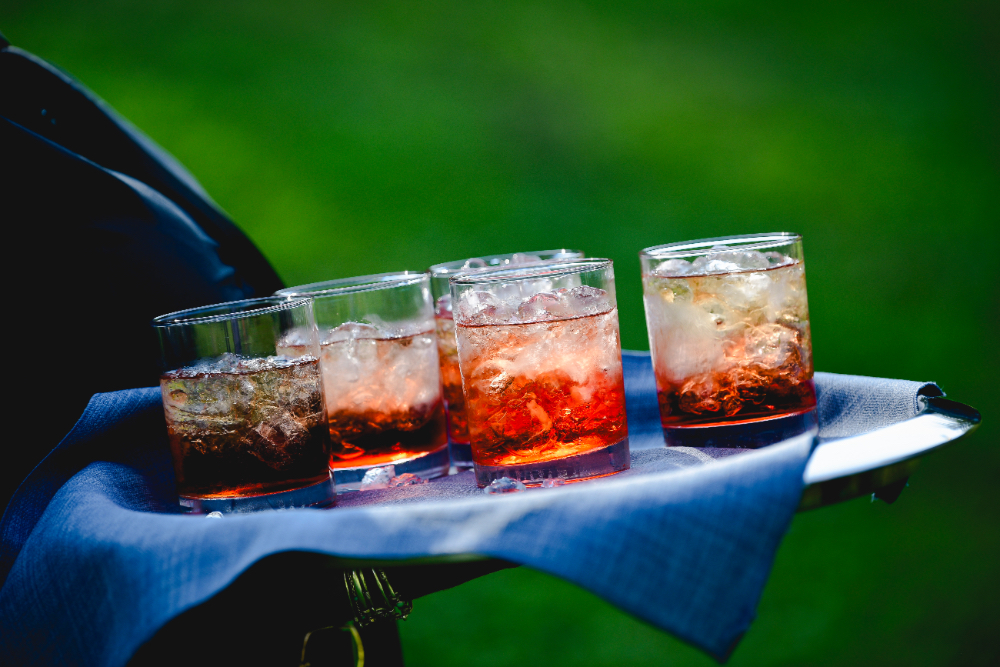 An arrangement of chilled cocktails with ice sits on a tray at a Buttermilk Falls Inn wedding reception.