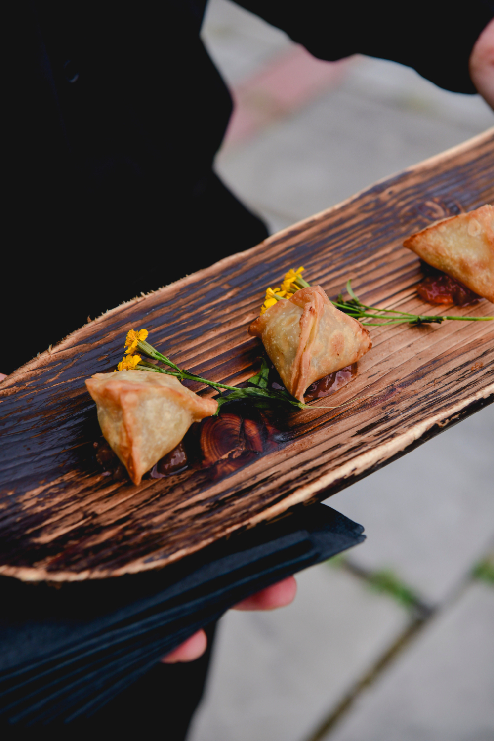 Savory hors d’oeuvres garnished with herbs on a tray.