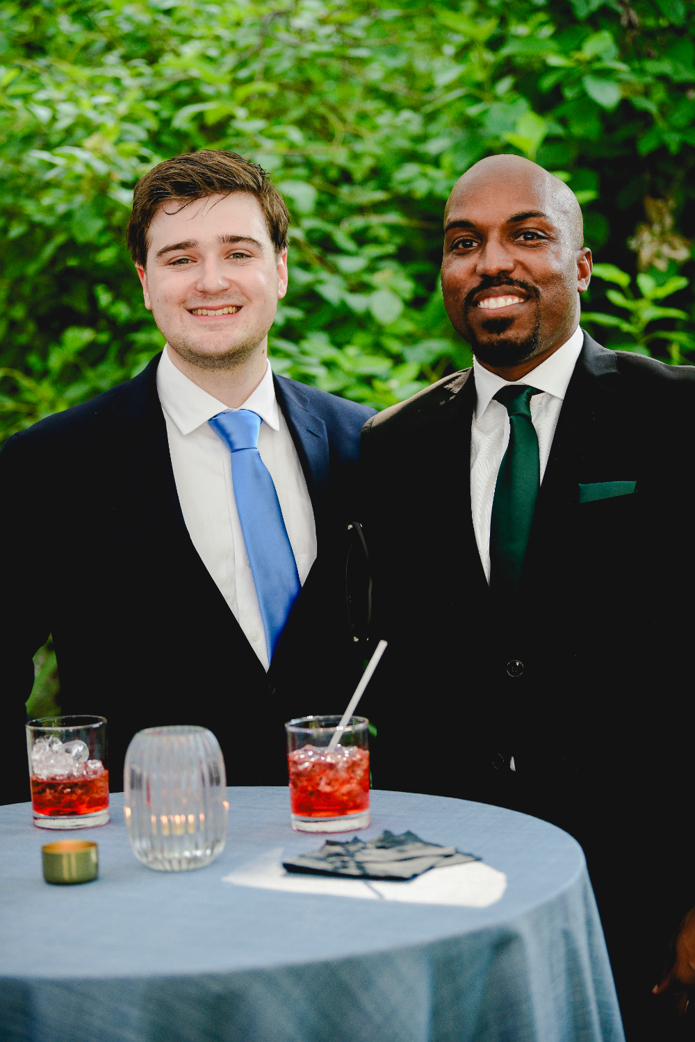 Guests mingle and enjoy drinks on the lawn during a Buttermilk Falls Inn wedding cocktail hour.