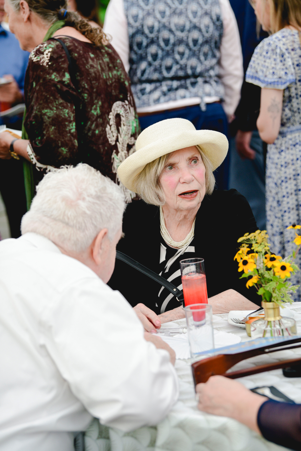 Guests chatting with cocktails during the outdoor reception.