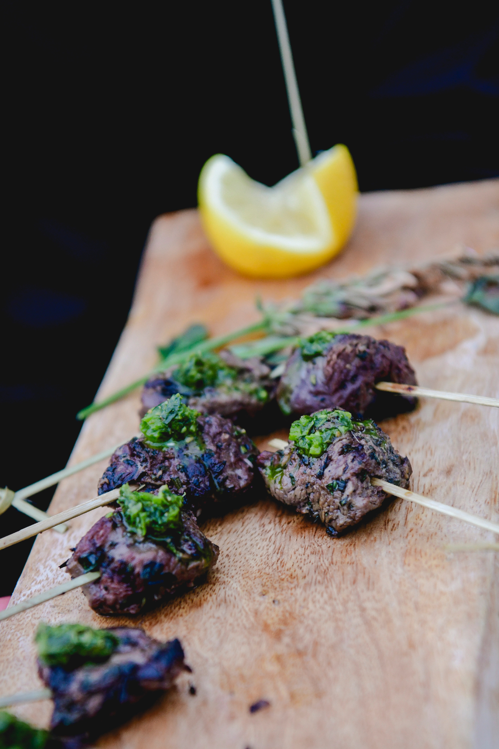Savory hors d’oeuvres garnished with herbs on a tray.