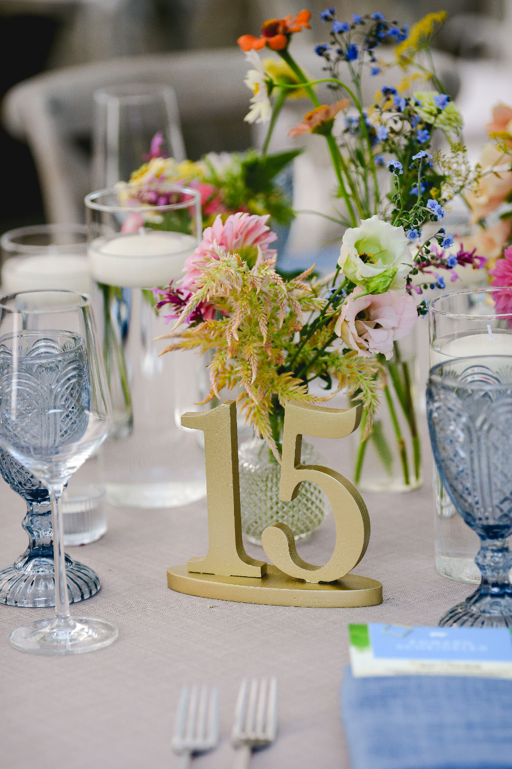 A close-up of a table number displayed among elegant décor.