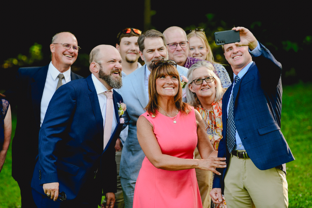 Guests snap photos and capture memories at a Buttermilk Falls Inn wedding.
