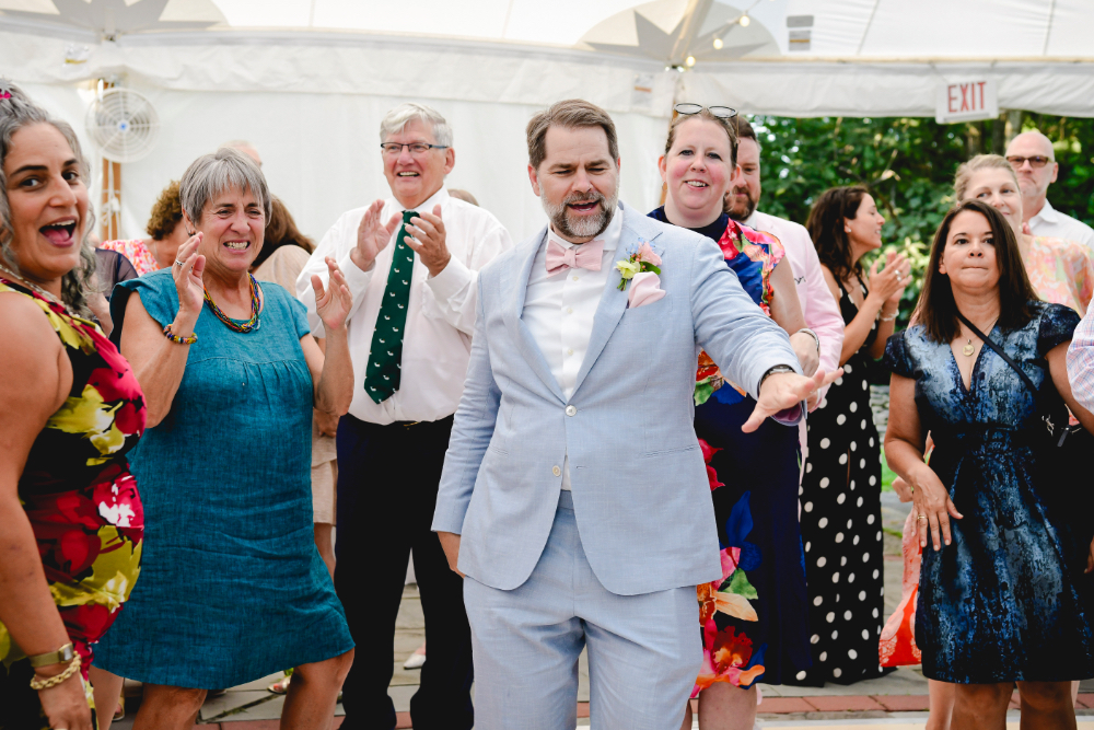 The grooms share a joyful moment on the dance floor at their Buttermilk Falls Inn wedding.
