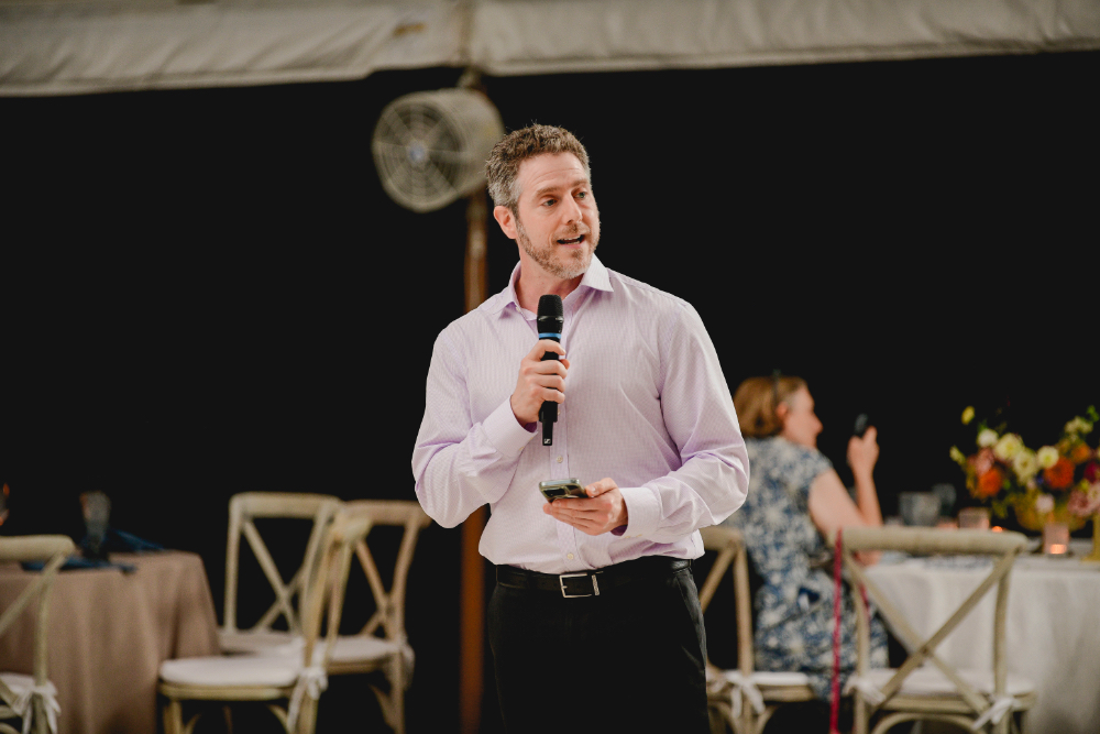 A guest delivers a heartfelt speech during the Buttermilk Falls Inn wedding reception.