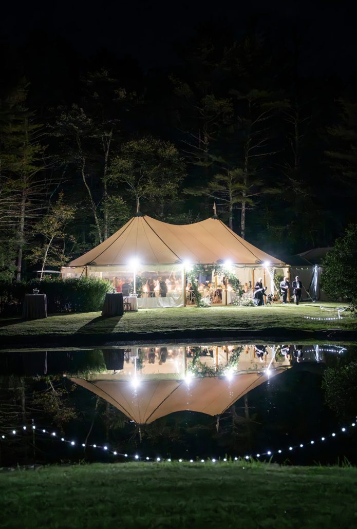 Outdoor wedding tent glowing at night at a private residence showing how to plan a home wedding reception