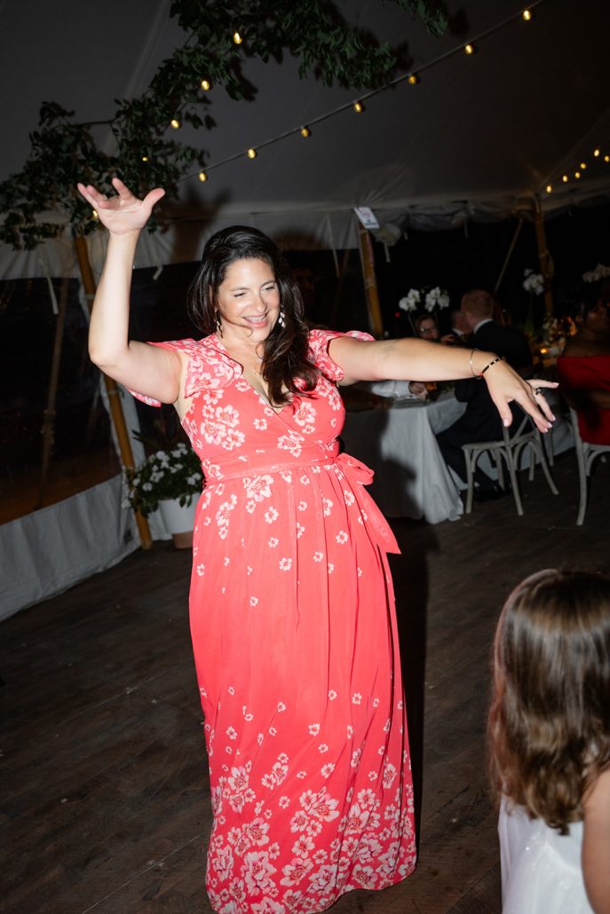 Guests dancing under the tent showing how to plan a home wedding celebration