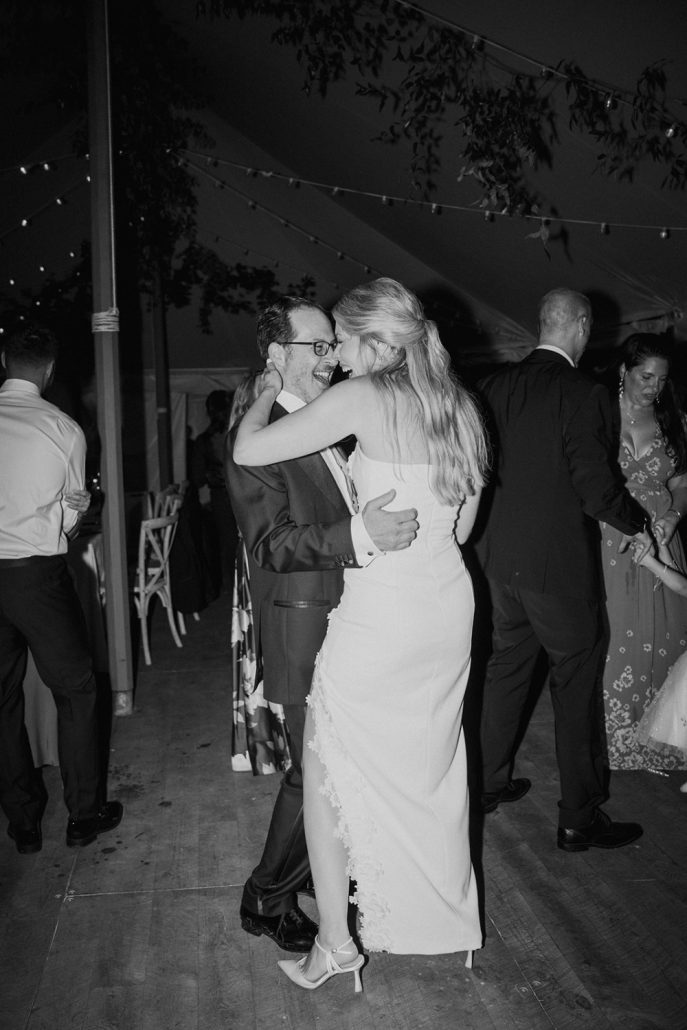 Bride and groom dancing together under the tent at their home wedding