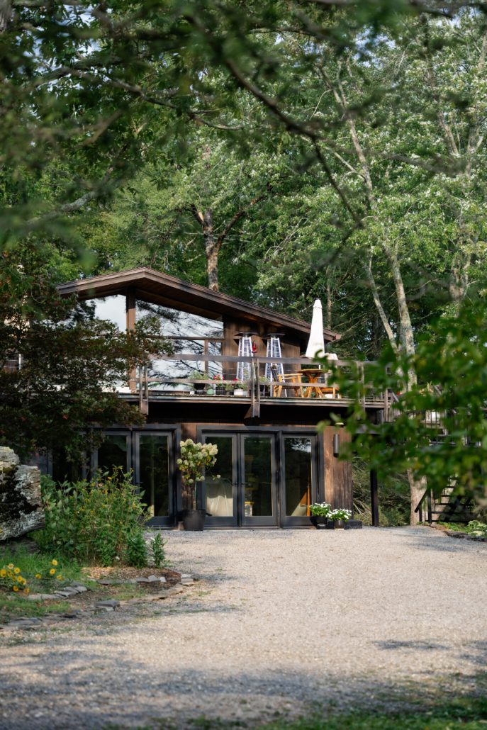 Modern wood and glass home nestled in a forest setting, offering a serene backdrop for intimate multi day wedding experiences.