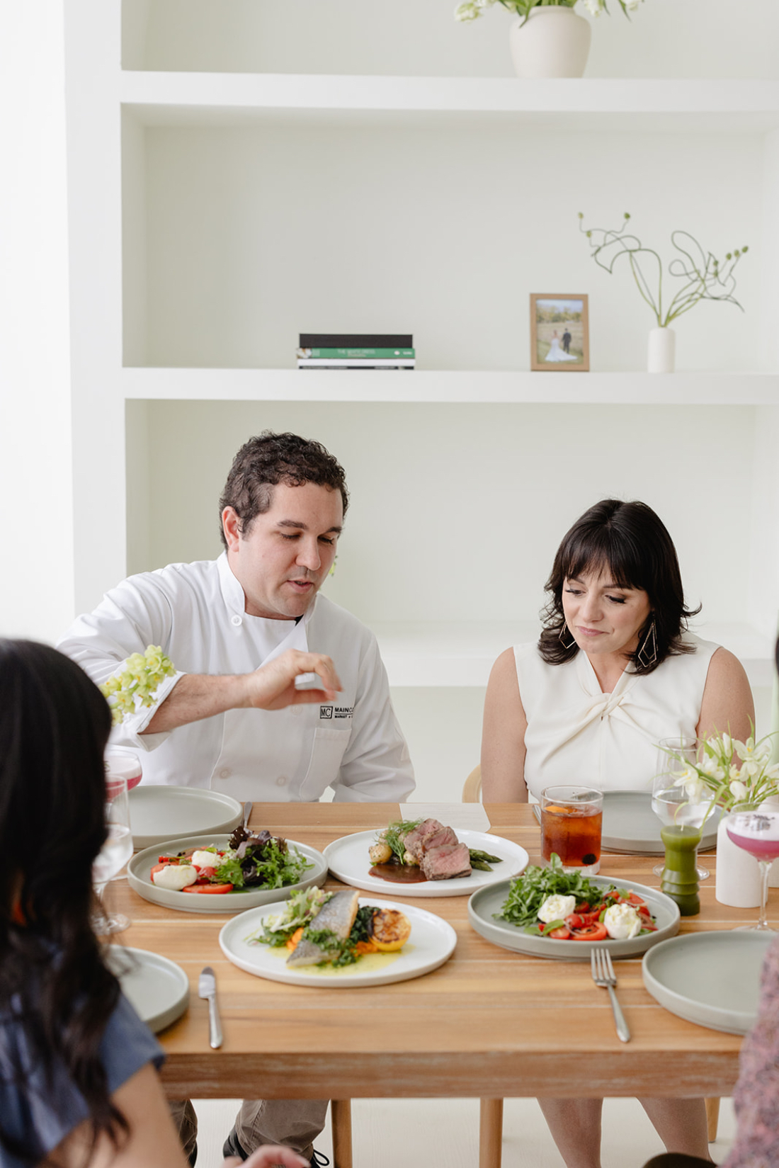 Full service wedding planner collaborating with a chef during a wedding menu tasting.