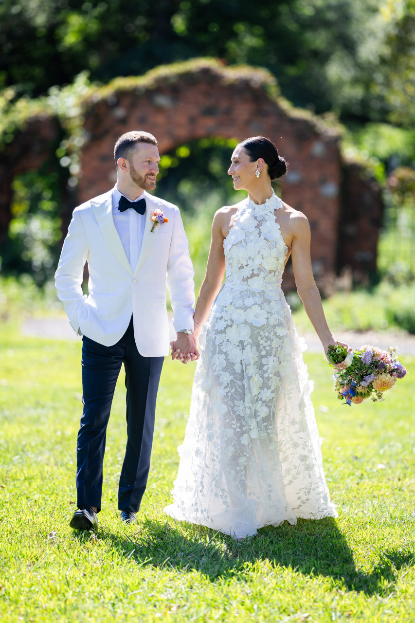 Newlywed couple walking hand in hand outdoors, showcasing how to choose wedding vendors who elevate photography and capture timeless moments.