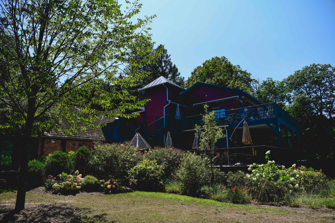 Charming countryside inn surrounded by gardens, perfect for hosting a multi-location wedding weekend celebration.