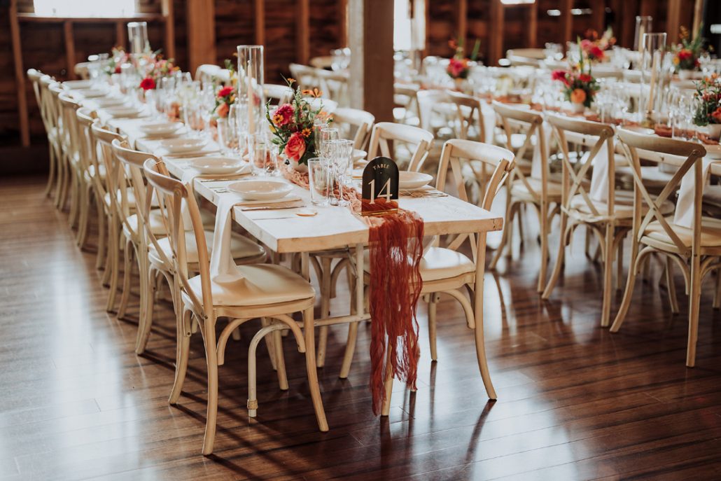 Beautifully styled reception tables with floral arrangements at a luxury wedding venue