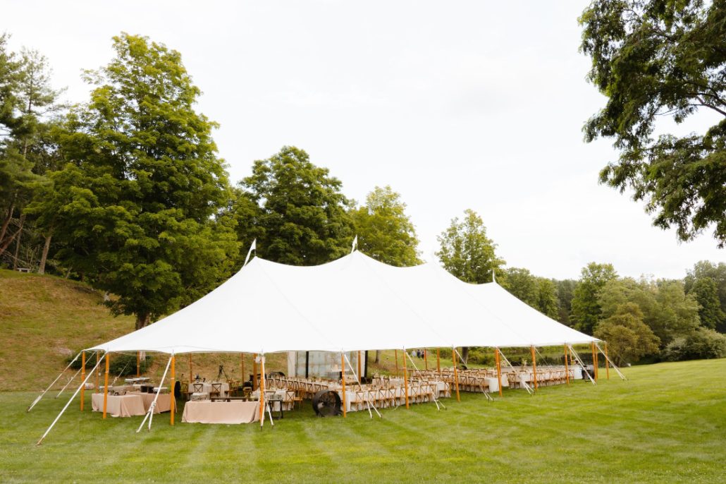 Luxury outdoor wedding tent with full reception layout, highlighting the importance of clear wedding contracts for large-scale events