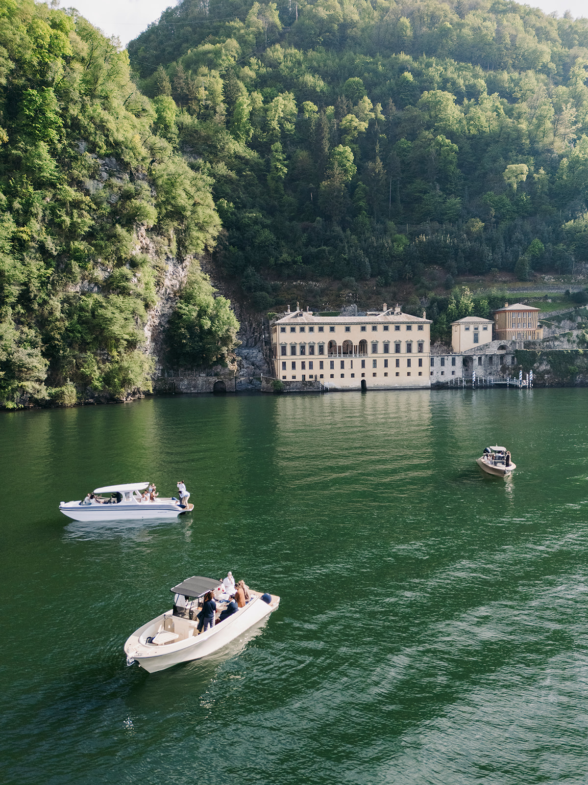 Guests enjoying a private boat tour on Lake Como during a luxury destination wedding Italy venue exploration.