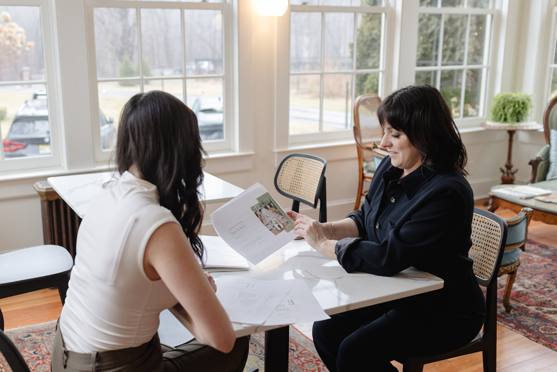 Couple meeting with a wedding planner to discuss venue scouting options and personalized venue recommendations. 