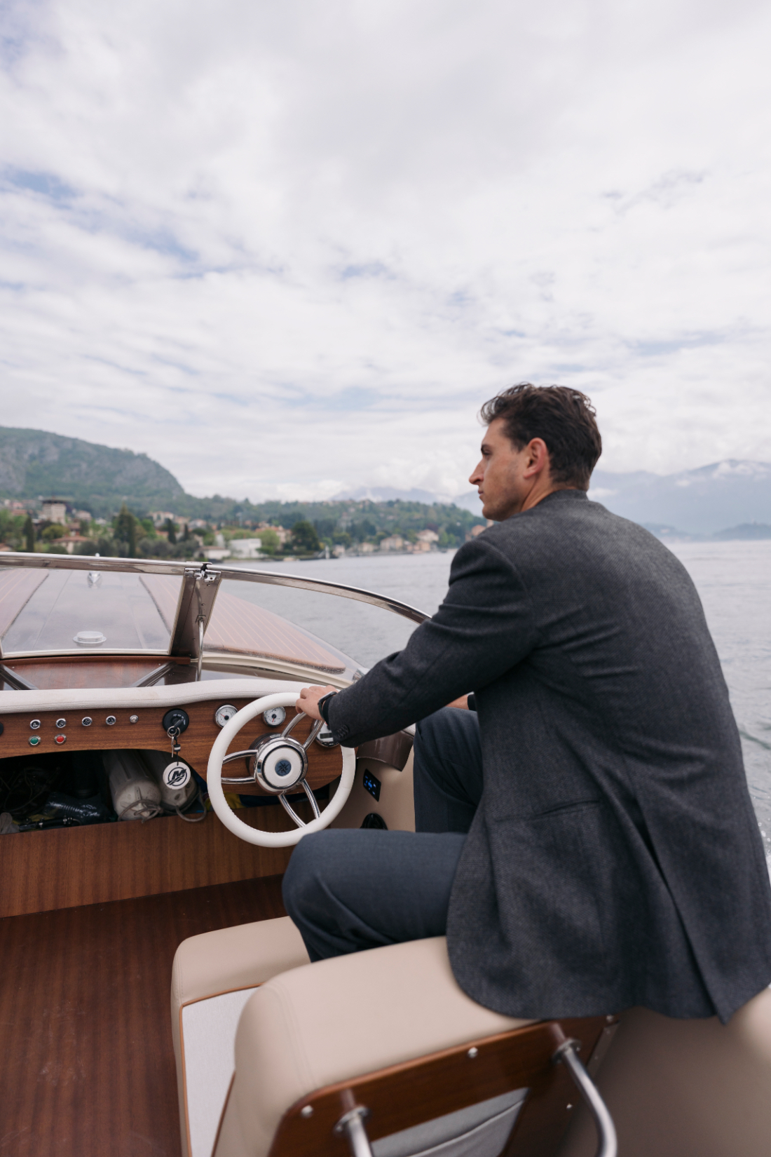 boat arriving by classic wooden boat for a Villa del Balbianello wedding on the waters of Lake Como.