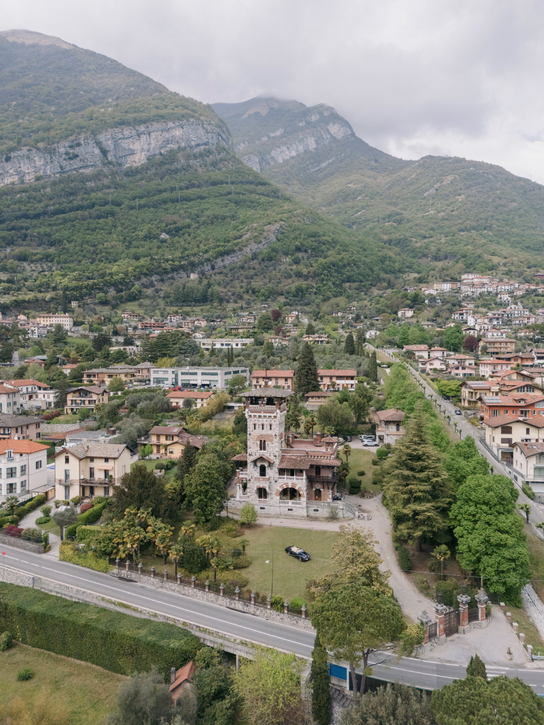 Aerial view of Villa Pessina Lake Como surrounded by mountains and lush gardens