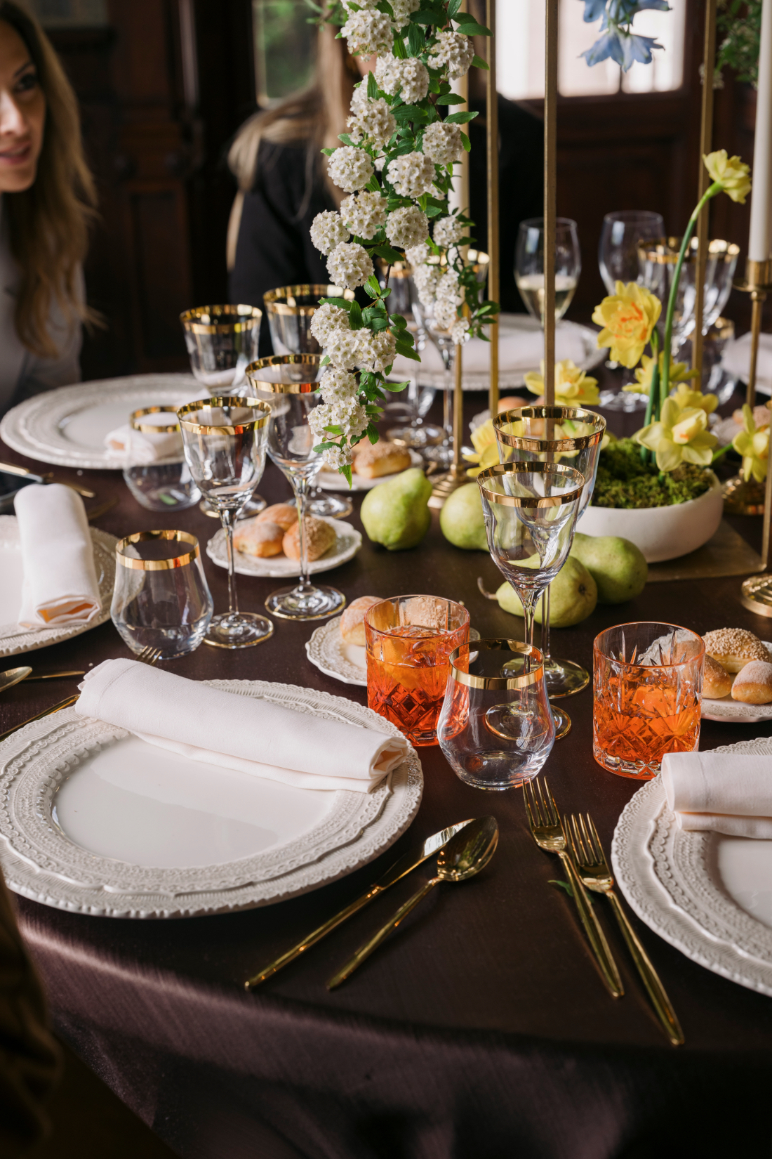 Elegant wedding tablescape with gold-rimmed glassware and fresh spring florals