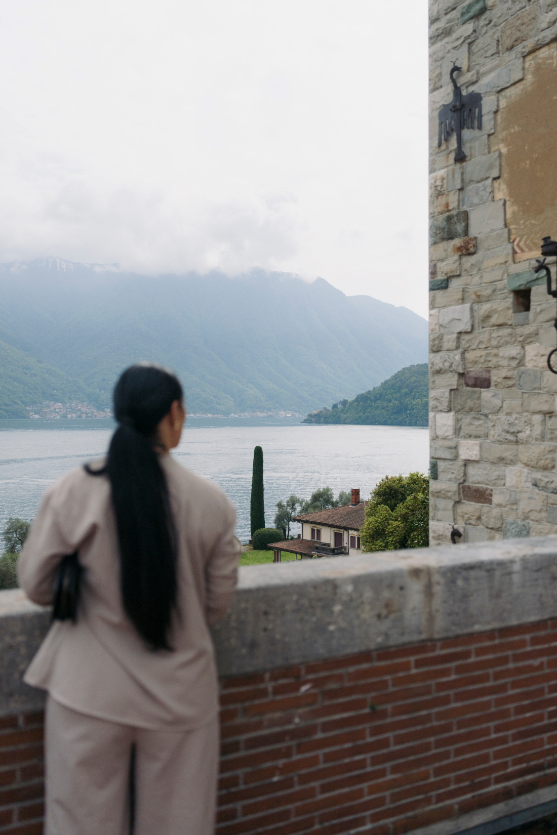 Guest admiring panoramic views of Lake Como from the terrace of a historic lakeside villa in northern Italy.