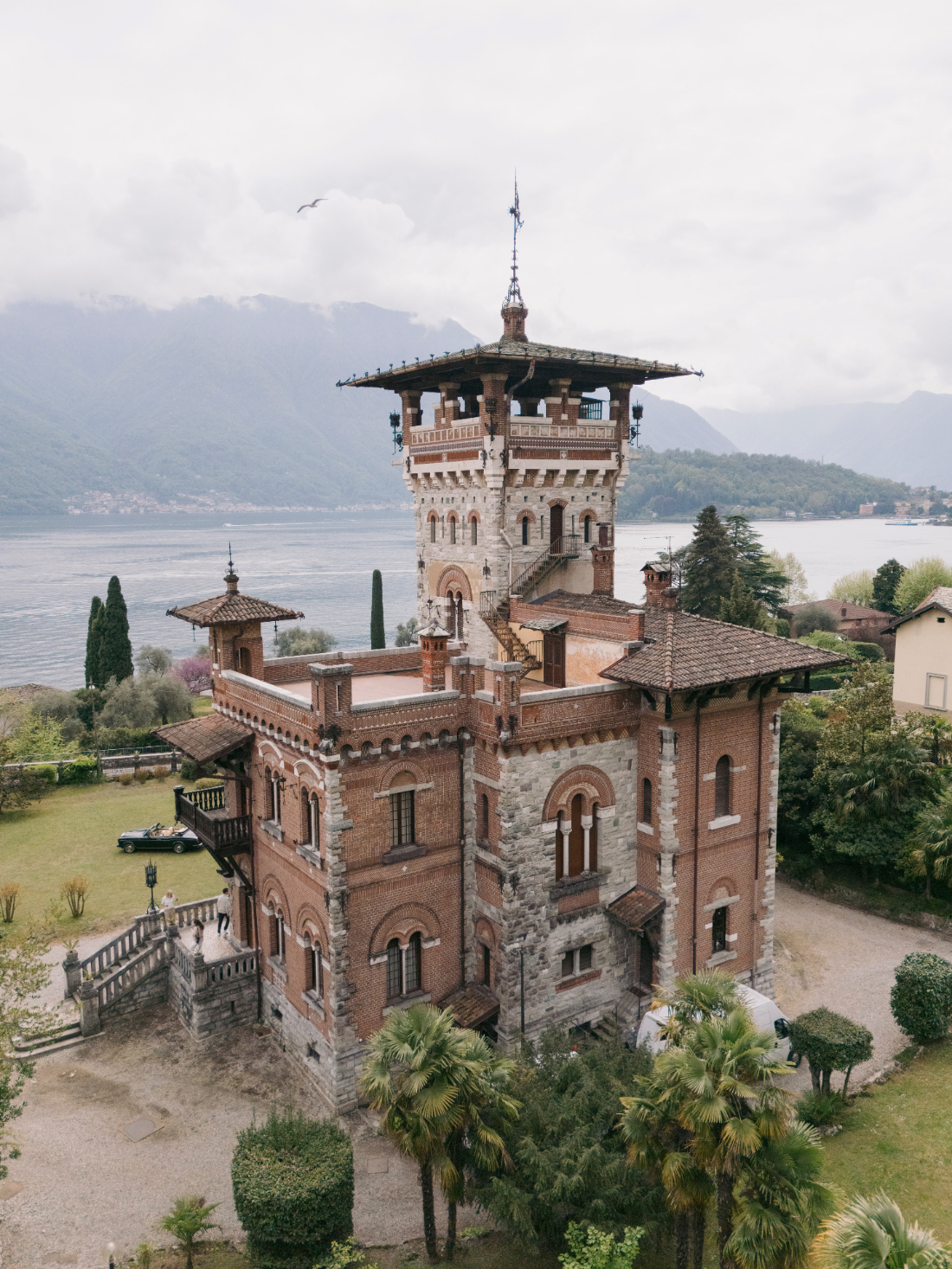 Side view of Villa Pessina Lake Como featuring the tower and lake backdrop