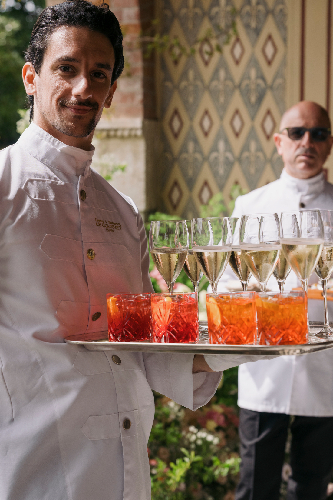 Waiter presenting welcome drinks at a luxury wedding celebration