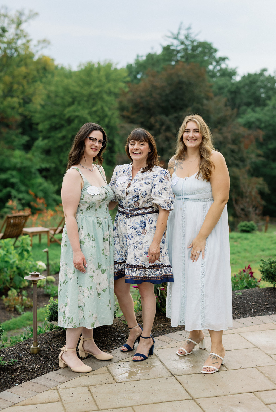 Three event professionals gathering outdoors at Mirbeau Beacon in the Hudson Valley