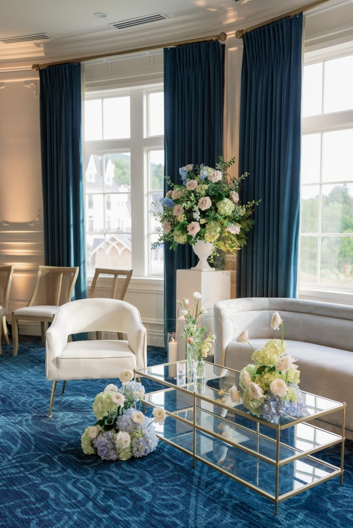 Elegant cocktail lounge with blue velvet accents and florals at a Beacon NY wedding venue