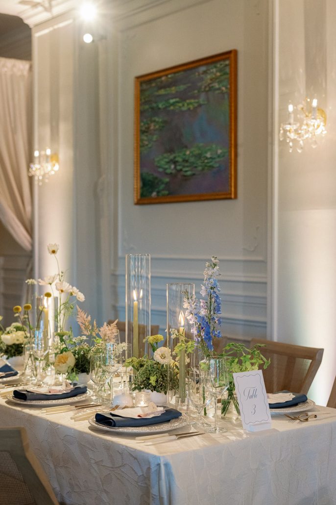 Monet-inspired tablescape with delicate florals, candles and blue accents at Mirbeau Beacon
