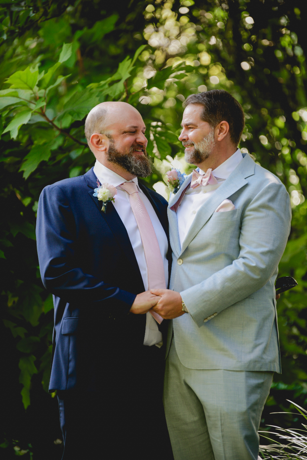 grooms hand in hand taking their portraits on their wedding day