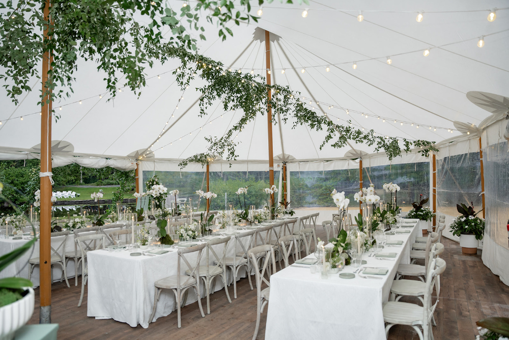 Elegant tented wedding reception with greenery, candlelight, and thoughtful details coordinated to reduce wedding planning stress.